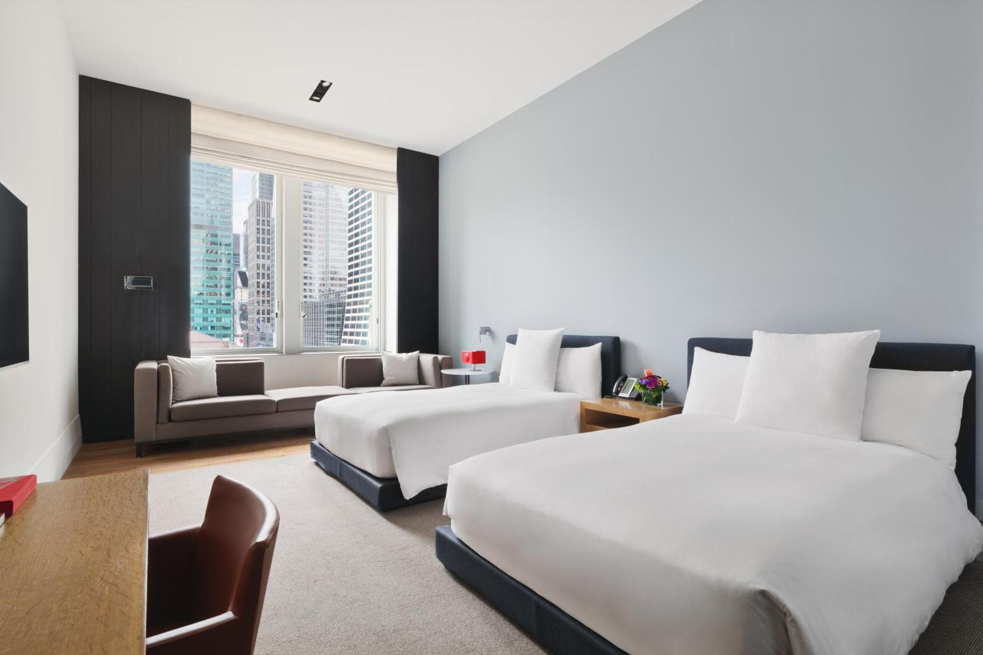 Deluxe Doppelzimmer mit 2 Doppelbetten und Blick auf die Stadt